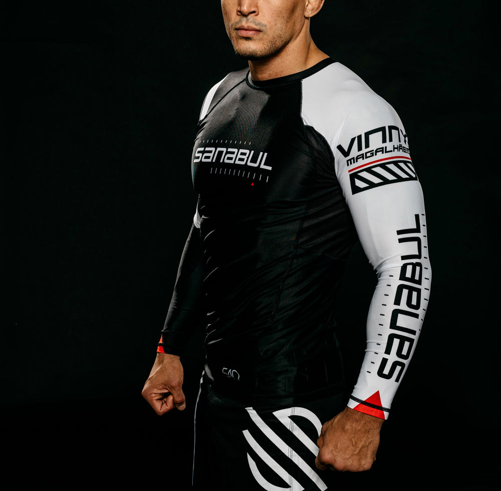 Man wearing a black and white rash guard with 'Sanabul' branding.