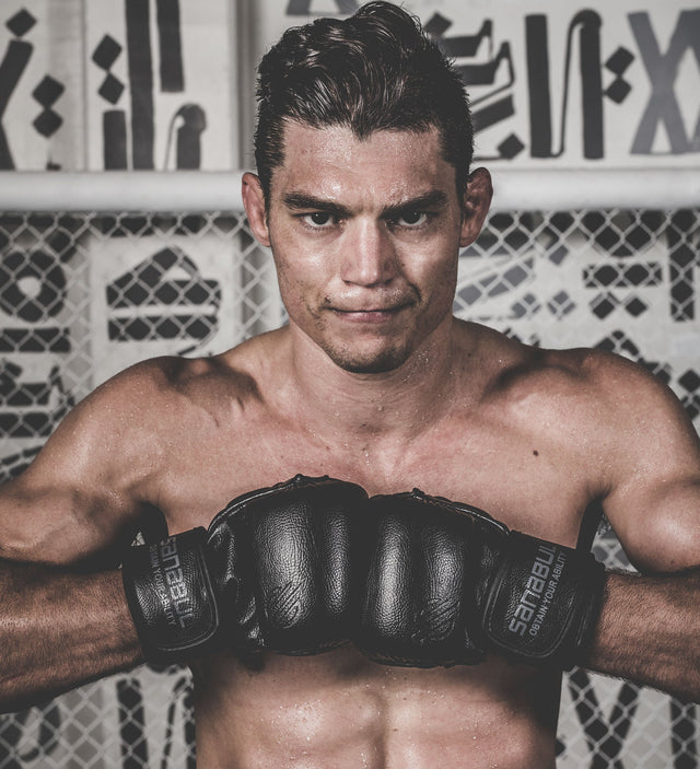 UFC fighter Alan Jouban wearing Battle Forged 7 oz MMA gloves and Shin Guards